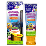 Guru Nanda Kids fluoride-free toothpaste tube and retail box showing colorful monster characters and strawberry mango branding.