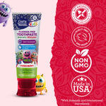 GuruNanda Kids mixed berry toothpaste beside red infographic panel showing badges for non-GMO, cruelty-free and made in USA