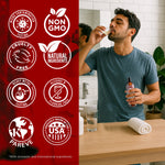 Lifestyle image of a man using a mouth rinse at a bathroom sink alongside icons for non-GMO, cruelty-free, natural ingredients and USA made.