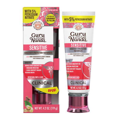 GuruNanda Sensitive toothpaste tube alongside its pink and white retail box showing clinical labeling and ingredient accents.