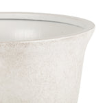 Close-up detail of the textured rim and inner lip of a light-gray gypsum urn planter