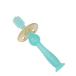 Translucent blue Haakaa silicone 360 baby toothbrush with suction base on white