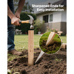 Person using a hammer to drive a pointed wooden stake into soil, close-up inset showing the sharpened stake tip.