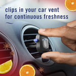 Hand placing a Febreze AUTO vent clip into a car vent with text 'clips in your car vent for continuous freshness' and citrus imagery