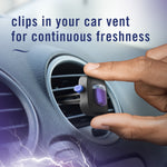 Hand clipping a Febreze Auto vent freshener into a round car vent, purple scent insert visible