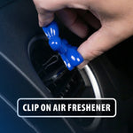 Hand clipping a small blue Little Pup balloon‑dog air freshener onto a car vent with overlay text ‘Clip on air freshener’