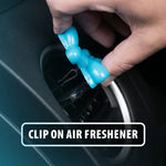 Hand clipping a blue Little Pup balloon-dog air freshener onto a car vent with 'clip on air freshener' label