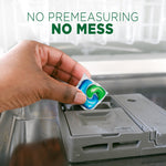 Hand placing a green-and-blue Cascade detergent pod into a dishwasher dispenser with headline 'No premeasuring No mess'.