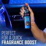 Hand holding Armor All Oracle Red Bull Racing 'Lights Out' air freshener spray inside a car interior
