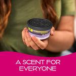 Hand holding a California Scents L.A. Lavender car air freshener can against a blurred background