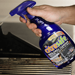 Hand holding a blue Citrusafe BBQ Grill Cleaner spray bottle angled over grill grates.