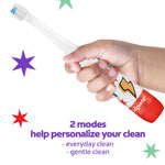 Child hand holding Colgate kids sonic toothbrush showing patterned handle and toothbrush head with star graphics