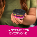 Hand holding a California Scents Coronado Cherry air freshener can with visible black decorative lid and pink product label