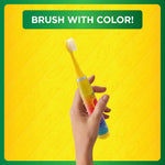 Hand holding a colorful Crayola sonic toothbrush against a yellow background with a 'Brush With Color!' banner at top.