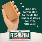 Hand holding a tan Fels‑Naptha soap bar above a boxed bar with text highlighting over 100 years of stain‑tackling formulation.