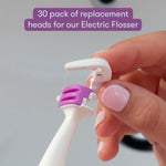 Hand holding a white and purple Frida electric flosser replacement head with overlay text about a 30-pack.