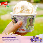 Hand holding a Glad Disney Princess paper snack bowl filled with ice cream, outdoor blurred background