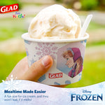 Hand holding a Glad Frozen paper snack bowl filled with ice cream, showing Anna artwork and Glad logo outdoors.