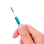 Close-up of a hand holding a GUM Proxabrush wide interdental brush showing bristles and grip