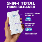Hand holding a textured white Magic Eraser against a purple background with callouts for Dawn cleaning power and fresh scent