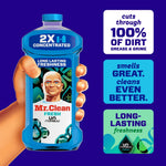 Hand holding a Mr. Clean 2X concentrated bottle with callouts: 'cuts through 100% of dirt', 'smells GREAT', and 'long-lasting freshness'
