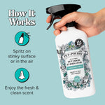Hand holding a Pet‑Pourri Pawsitively Fresh spray bottle with infographic text explaining how the spray works