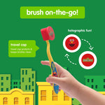 Hand holding yellow Sesame Street toothbrush with red travel cap; graphic callouts show holographic travel cap design and travel use