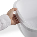 Hand holding the rim of a white Sterilite plastic dishpan, close-up on the handle area