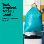 Hand holding a full teal Glad drawstring bag above a stainless step trash can with teal text panel