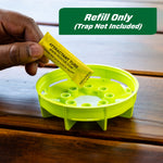Hand holding a yellow attractant tube above a lime-green trap insert with text overlay reading refill only (trap not included)