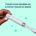 Hand sliding a quip toothbrush into its white travel cover, shown with text about the cover doubling as a stand