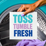 Hand inserting a dryer towelette into a dryer drum with bold text ‘TOSS TUMBLE FRESH’