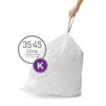 Hand holding the tied top of a full white trash bag with an overlay circle indicating 35–45 litre and a purple 'K'.