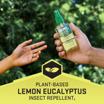 Hand passing a bottle of Repel lemon eucalyptus spray against a green blurred outdoor background