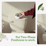Hand placing an Arm & Hammer Essentials odor eliminator can on top of a toilet tank in a tiled bathroom scene