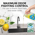 Hand pouring Camco TST lemon-scented liquid toward a sink with grey water safe badge