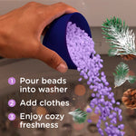 Hand pouring purple laundry scent beads from a measuring cup into a washer with step-by-step usage text and decorative pine sprigs.