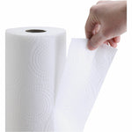 Hand pulling a perforated sheet from an upright white paper towel roll, revealing embossed circular texture.