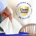 Hand pulling a white tissue from a purple Kleenex box next to a 'Clean Shield 3X better' shield badge