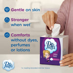 Hand pulling a tissue from a Puffs Ultra Soft cube next to text highlighting gentle, stronger when wet, and dye-free comfort