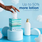 Hand reaching to pull a tissue from a Puffs Plus Lotion cube next to a lotion bottle and 'Up to 50% more lotion' headline