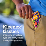 Hand placing a colorful Kleenex On-The-Go pocket pack into a pants pocket with text about being gentle on watery eyes and runny noses.