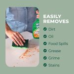 Close-up scene of a hand scrubbing a dirty countertop with a green sponge while a Simple Green spray bottle is partially visible