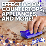 Close-up of a hand scrubbing a stained countertop with a purple sponge and large text about effectiveness