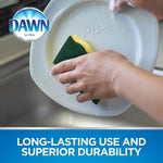 Person scrubbing a white plate with a green-and-yellow Dawn sponge, Dawn logo in corner and product benefit text below