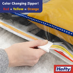 Close-up of hand using the fast grip tab to seal a Hefty vacuum bag, showing color-changing zipper detail.