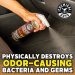Hand spraying Chemical Guys leather-scent odor eliminator inside a car with bold text about destroying odor-causing bacteria