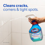 Hand holding a Clorox Bleach Foamer spray bottle aimed at tiled shower wall with copy about cleaning cracks and tight spots