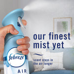 Hand pressing a blue Febreze Air Mist bottle spraying a fine mist with text 'our finest mist yet'
