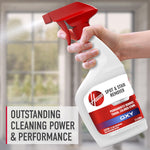Hand holding a Hoover spray bottle with red trigger in front of a blurred window, text reads outstanding cleaning power & performance